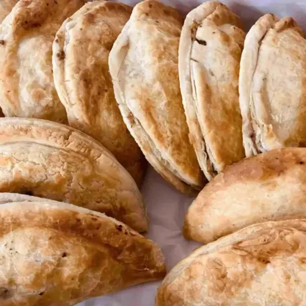 A dozen golden baked traditional Cornish-style pasties.