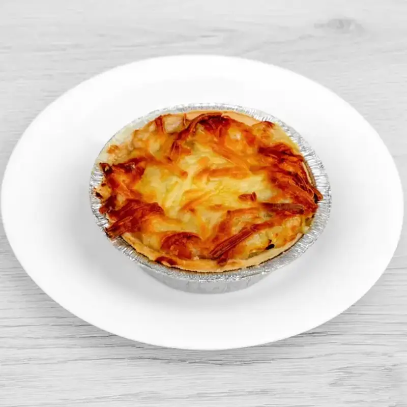 Golden baked Homity pie filled with potato, cheese, and onion.