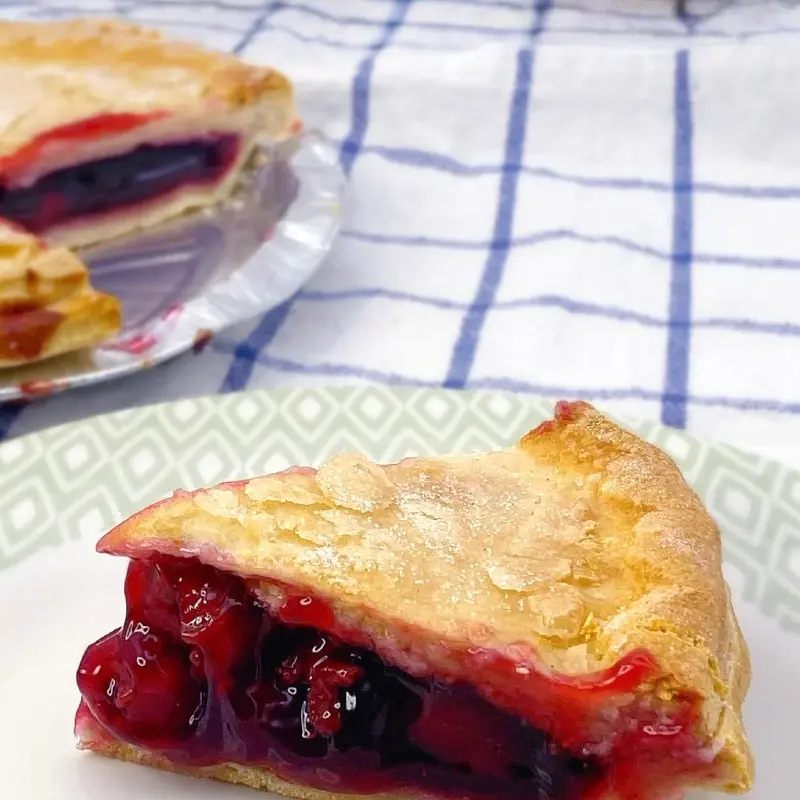 Golden baked cherry pie with a sweet, juicy cherry filling.