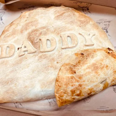 Extra-large Father’s Day pasty with golden flaky pastry crust.