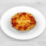 Golden baked Homity pie filled with potato, cheese, and onion.