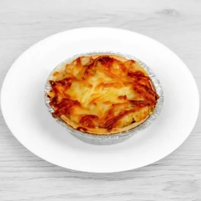 Golden baked Homity pie filled with potato, cheese, and onion.