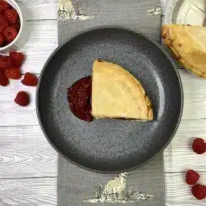 Golden baked raspberry pie with sweet-tart raspberry filling.