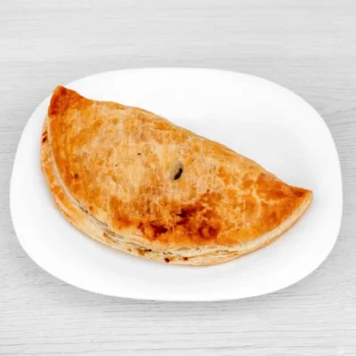 Freshly baked traditional Moore’s pasty with golden flaky pastry.